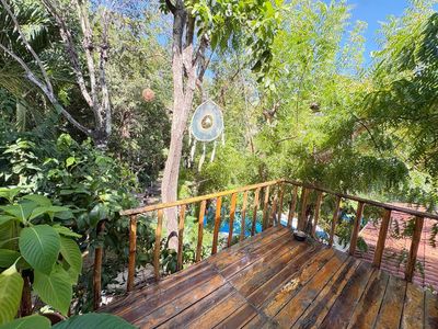 The wooden sky deck looking out over the treetops and pool